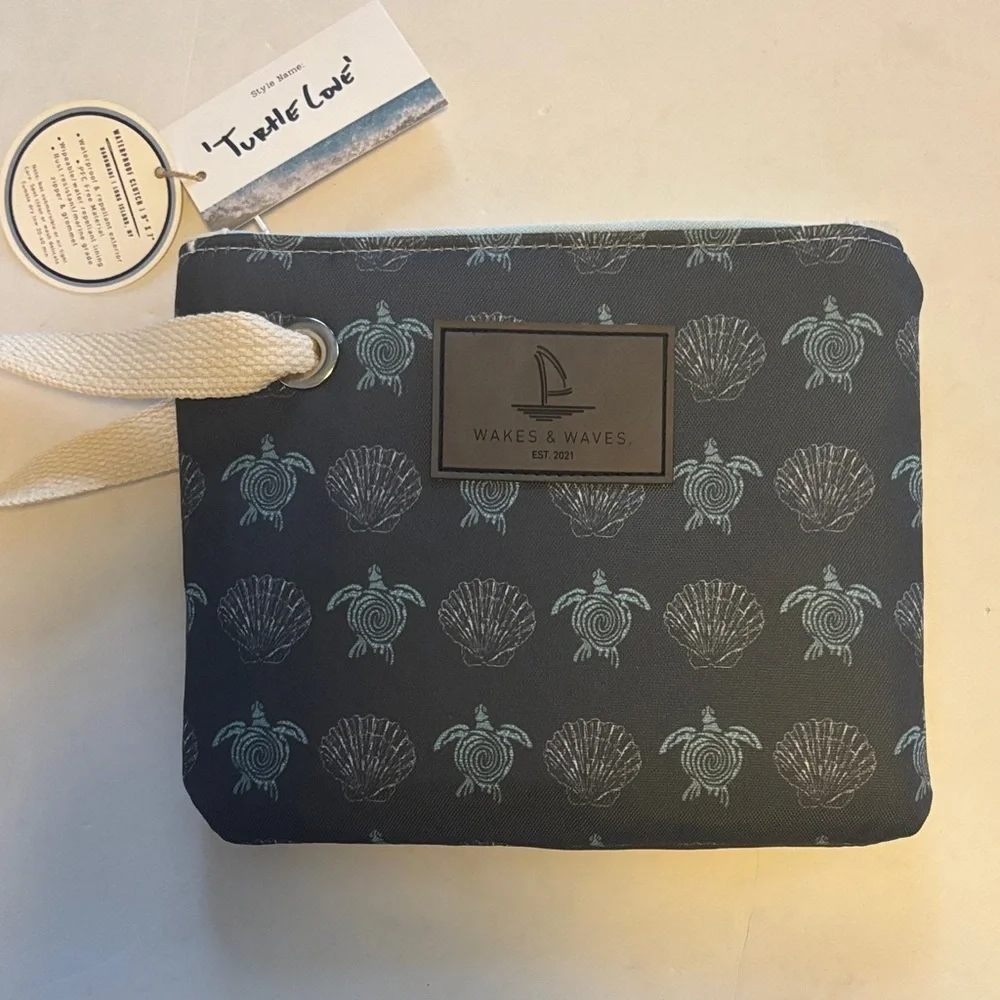 WAKES & WAVES BLUE WRISTLET WITH TURTLE DESIGN WATERPROOF CANVAS LIKE MATERIAL